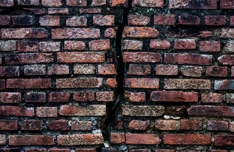 Stair-step crack running through an old brick wall